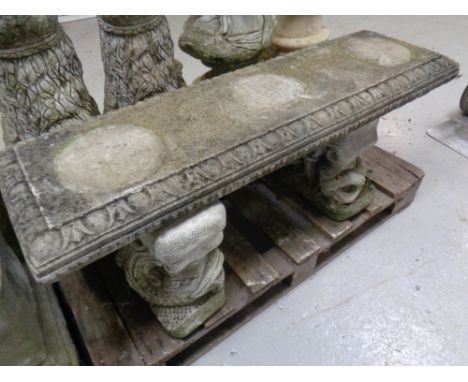 A concrete garden bench with Koi fish supports. Width 115cm 