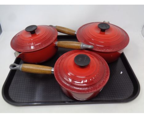 3 Le Creuset ceramic wooden handled saucepans.