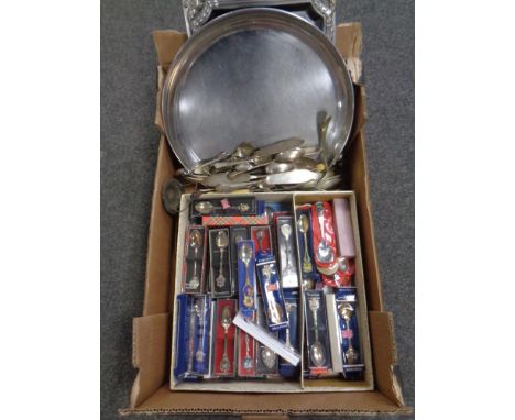 A box containing a large quantity of plated flatware and boxed crested spoons together with silver plated and stainless steel