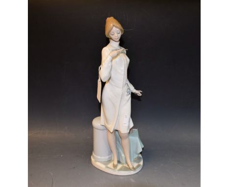 Lladro - figure of a standing nurse checking a thermometer, 34cm in height