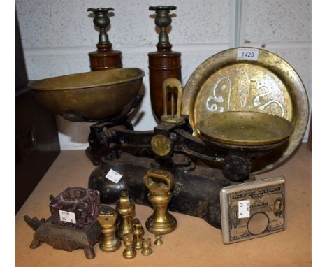 A set of Boot's cast iron kitchen balance scales, with brass pans and set of graduated brass weights; a pair of treen candles