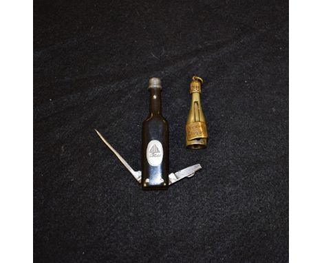 A Novelty Veuve Cliquot Champagne bottle cigar cutter, 45mm high;  a Bass beer bottle shaped two bladed pipe cleaning pocket 