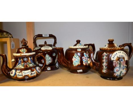A Victorian bargeware treacle glazed teapot inscribed 'Love at Home 1883'; others later (4)