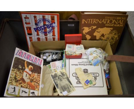 A Neverdone fibre trunk containing loose stamps and stamp albums, postcards etc