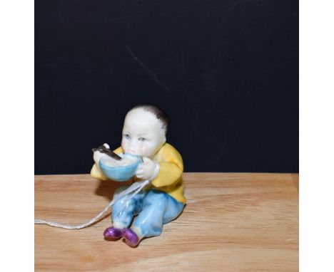 A Royal Worcester Chinese boy eating, by FG Doughty