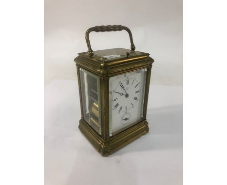 A good 19th century eight-day brass carriage alarm clock with two train movement striking on a gong, the white enamelled dial