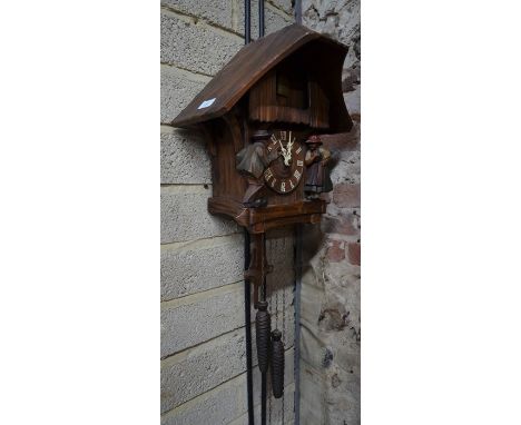 A Continental carved and stained wood cuckoo clock (circa 1930s), 40 cm high
