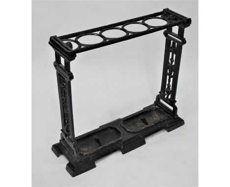 An antique cast iron four division umbrella/stick stand, in the neo-classical revival style with twin drip trays, 60 cm x 20 
