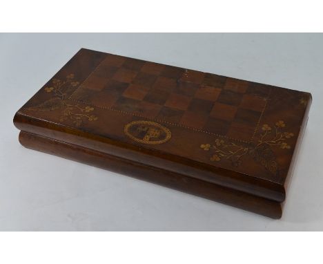 An antique Irish Killarney ware yew wood folding chess/backgammon board, inlaid with shamrock, harp and Ross Castle ovals, to