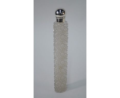 A Victorian heavy cut glass cologne/spirit flask of long oval baton form, the silver screw bun cover with silver gilt collar,