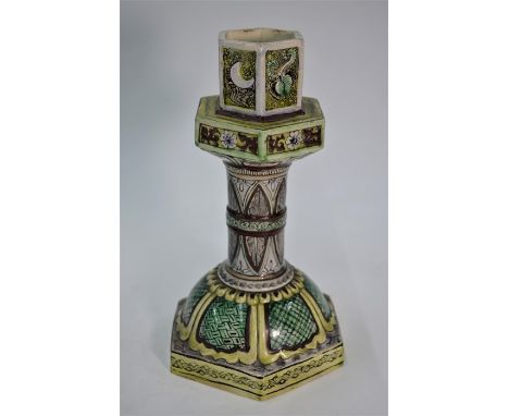 A 19th century Ottoman pottery candle stick of octagonal form painted in soft polychrome enamels, 27 cm high&nbsp;