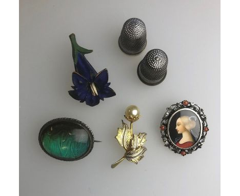 A Kingfisher feather brooch, a carved and painted flower brooch, Damascene brooch, an oval portrait miniature pendant and two
