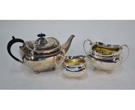 A matched three-piece silver tea service of oblong form on ball feet, James Dixon &amp; Son, Sheffield 1919/25/26, 26 oz gros