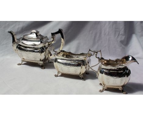 A George IV silver three piece tea set, comprising a rectangular teapot, cream jug and sugar basin, Dublin, 1815, James Le Ba