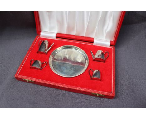 An Elizabeth II silver miniature tea service comprising a hot water pot, teapot, cream jug and sugar basin, Birmingham, 1979,