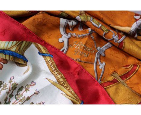 An orange silk Hermes Scarf, decorated with scrolls etc, together with another silk Hermes scarf decorated with floral sample