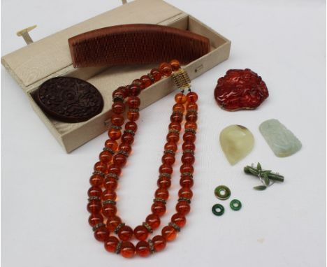 A green jade pendant carved with birds, together with a necklace, brooches, comb etc   CONDITION REPORT:  carved brooch is cr
