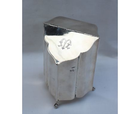 An Edwardian silver tea caddy, with a tapering hinged fall, serpentine front on three claw and ball feet, Birmingham, 1910, J