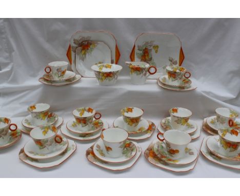 A Shelley part tea service, decorated in the Cape Gooseberry pattern, comprising twelve cups, twelve side plates, thirteen sa