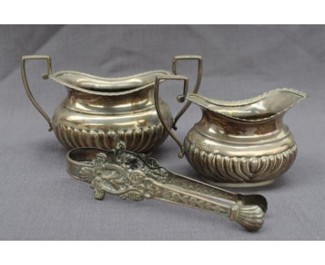 A late Victorian silver cream jug and twin handled sugar basin, with a gadrooned edge and body, Chester, 1896, approximately 