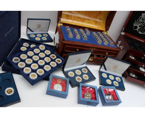 Silver Dollars contained in a collectors cabinet together with Danbury Mint single state quarters contained in a domed trunk,