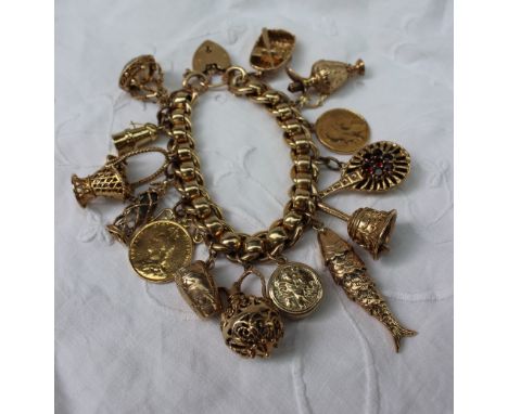 A 9ct yellow gold charm bracelet, set with numerous charms including a miners lamp, coracle, hand bell, reticulated fish, bas