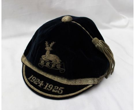 A blue velvet cap with a silver thread tassel, embroidered with a stag and the initials B-R-F-C, the peak embroidered 1924-19