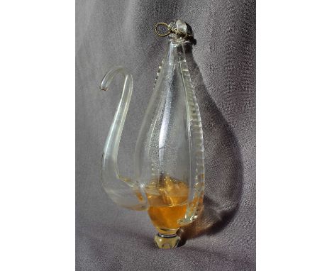 A 19th Century clear glass water barometer, with a moulded suspension loop and long slender spout, 24.5cm high with paper lab