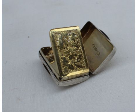 A George IV silver vinaigrette, of rectangular cushion form, decorated with scrolling leaves, with a pierced silver gilt gril