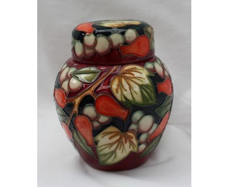 A Moorcroft ginger jar and cover decorated in white berries and red rose hips, impressed and painted marks, dated 2003, 11cm 
