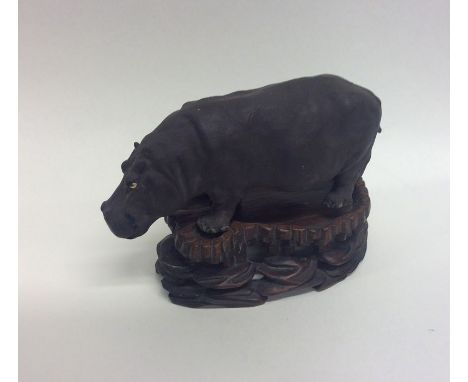 A small Britain's model of a hippopotamus on carved wooden stand. Est. £30 - £40.
