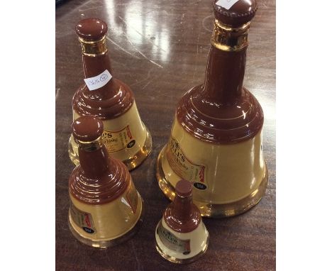 Four x Wade decanters of Bell's Specially Selected Old Scotch Whisky containing 75.7cl, 37.8cl, 18.9cl and one other of liqui