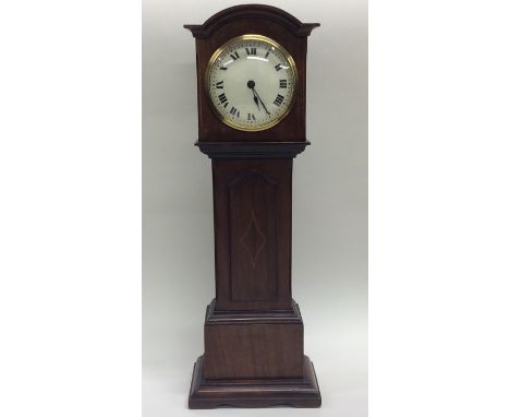 A good Edwardian inlaid eight day miniature longcase clock with white enamelled dial. Approx. 44 cms high. Est. £80 - £120.