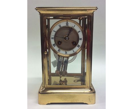 A good quality brass mantle clock with white enamelled dial and striking movement. Approx. 22 cms high. Est. £150 - £200.