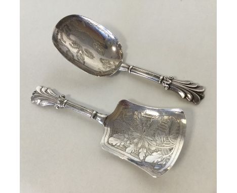 A bright cut silver caddy spoon, the bowl decorated with flowers and leaves. Birmingham. By George Unite. Together with one o