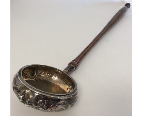 An unusual silver ladle with embossed decoration. London. By DH. Approx. £20 - £30.