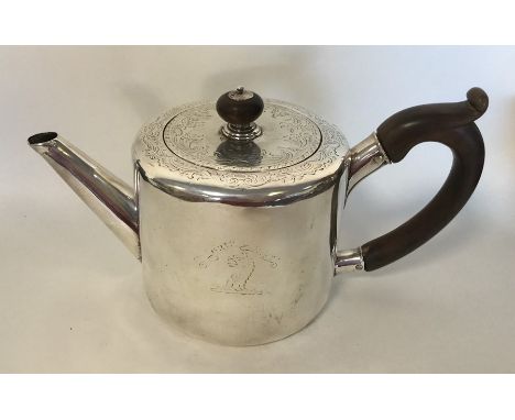 A Georgian silver bachelor's teapot engraved with flowers and leaves and crested side. London 1770. By SC&amp;IC. Approx. 470
