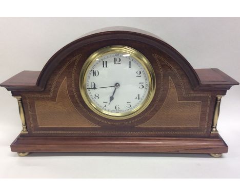 A good quality Edwardian eight day French inlaid mantle clock with white enamelled dial on brass bun feet. Approx. 30 cms acr
