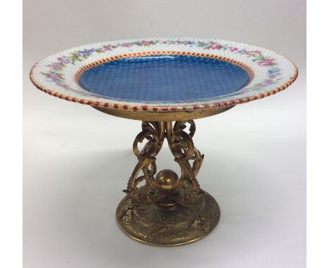 An attractive enamel plate on gilded stand and scroll base. Approx. 20 cms in diameter. Est. £100 - £150.