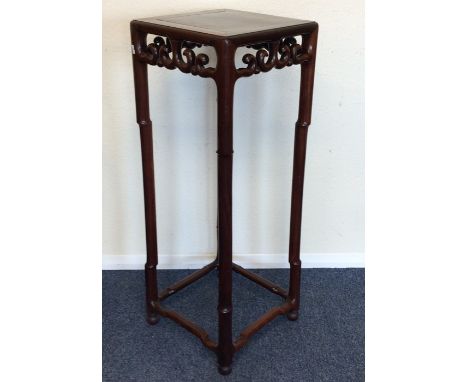 A good large Chinese hardwood stand with scroll decoration and stretcher base. Est. £500 - £800.