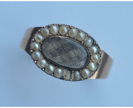 A heavy pearl mounted mourning ring. Approx. 5 grams. Est. £120 - £150.