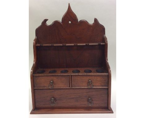 A small mahogany pipe stand with fitted interior. Approx. 35 cms high. Est. £20 - £30.