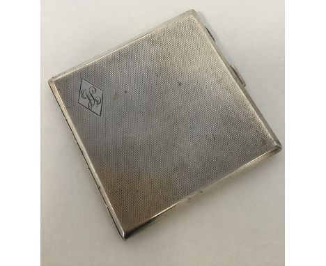 A good quality square silver engine turned cigarette case together with a pencil. Approx. 144 grams. Est. £20 - £30.