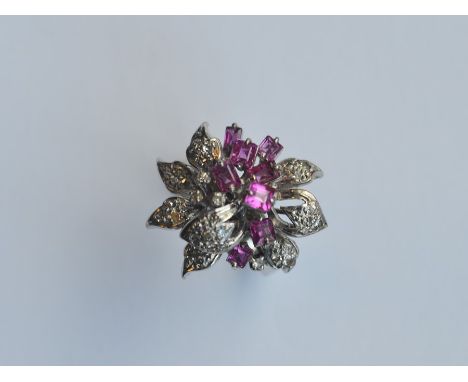 A 14 carat ruby and diamond ring in the form of a flower. Approx. 7.6 grams. Est. £120 - £150.