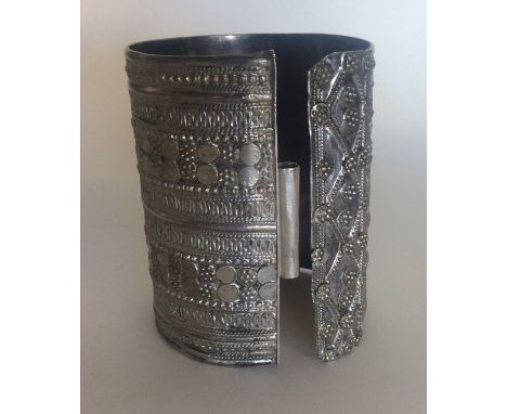 A good silver torque bangle decorated with balls and wriggle work. Approx. 152 grams. Est. £30 - £40.