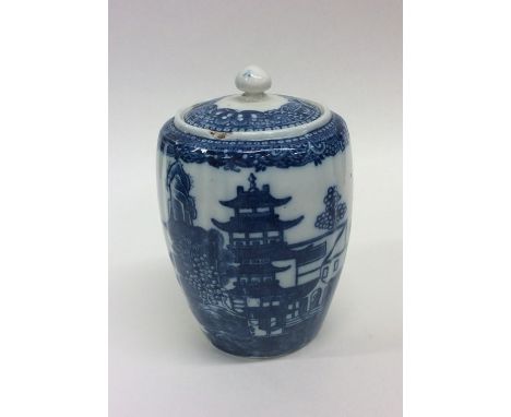 An 18th Century Caughley blue and white porcelain fluted tea caddy and cover, the sides painted with Oriental pagodas and fig