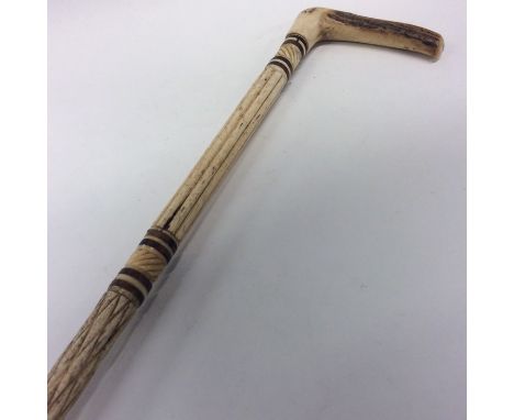 An Antique carved ivory walking stick with reeded decoration. Est. £40 - £60.