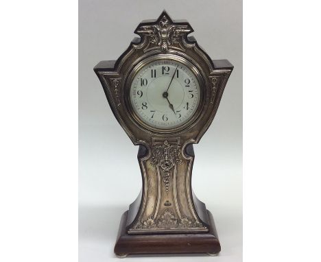 A large silver mounted mantle clock in mahogany case with white enamelled dial. Approx. 32 cms high. Birmingham. By CB&amp;S.