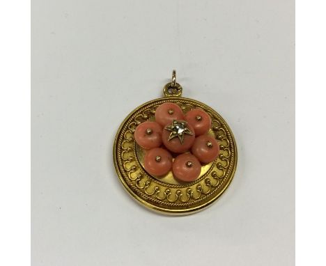 A good Victorian coral target pendant with central diamond to loop top and ring clasp. Approx. 8 grams. Est. £250 - £350.