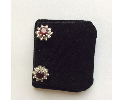 A pair of gold mounted ruby and diamond cluster earrings. Est. £80 - £120.